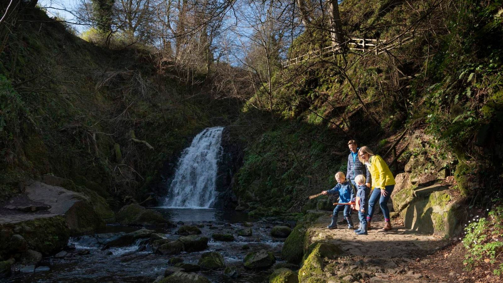 Family watching the river at Gleno Waterfall